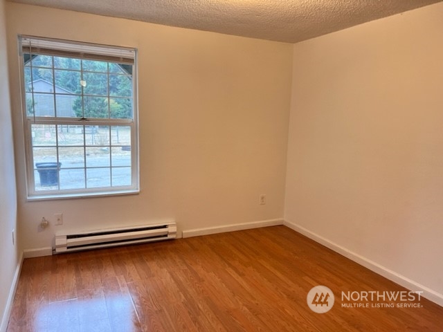 3915 Mason Loop Road Tacoma, WA 98409 - Photo 35 of 38 a view of a room with wooden floor and a window