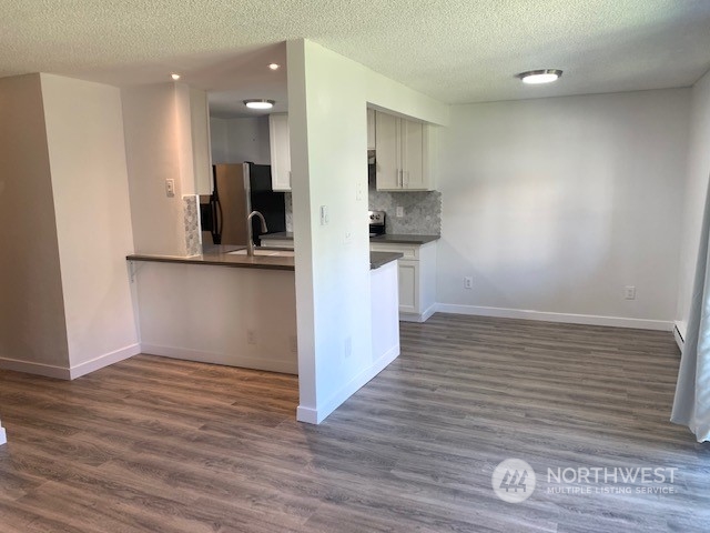 3915 Mason Loop Road Tacoma, WA 98409 - Photo 7 of 38 a view of cabinets and wooden floor