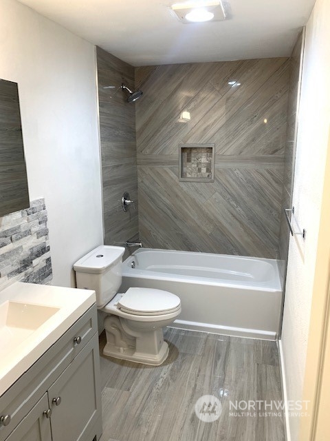 3915 Mason Loop Road Tacoma, WA 98409 - Photo 8 of 38 a bathroom with a sink a toilet and bathtub
