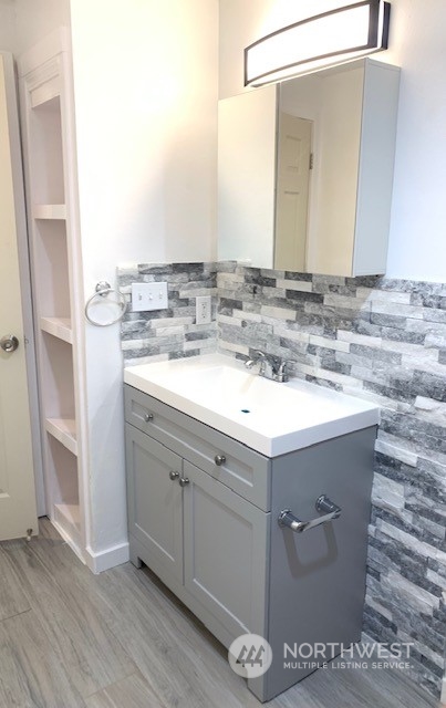 3915 Mason Loop Road Tacoma, WA 98409 - Photo 9 of 38 a bathroom with a sink and a mirror