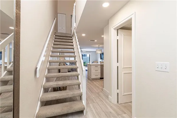 a view of entryway and hall with wooden floor