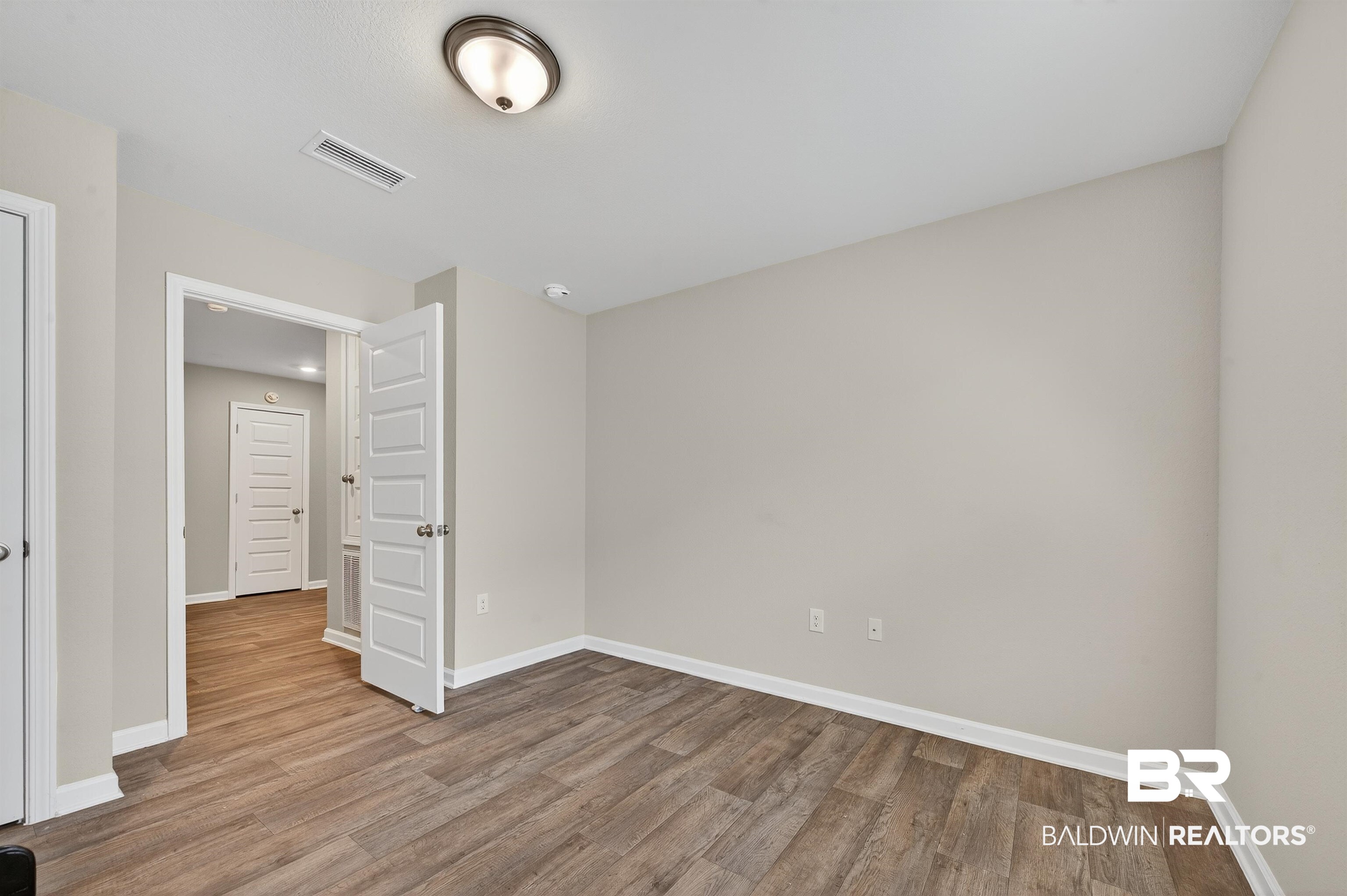 7429 Brompton Drive Foley, AL 36535 - Photo 43 of 50 Unfurnished bedroom with light wood-style flooring and baseboards
