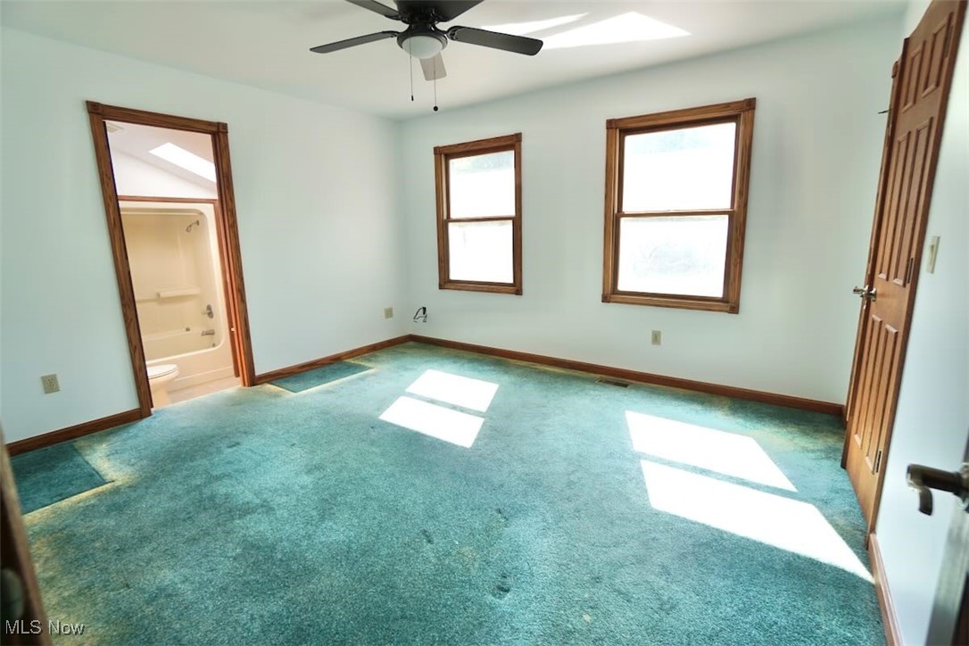 7060 Gates Road Gates Mills, OH 44040 - Photo 25 of 38 Unfurnished bedroom featuring carpet flooring, a ceiling fan, ensuite bath, and a skylight