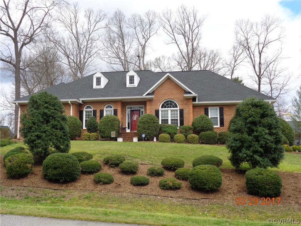 13018 Chipstead Road Chester, VA 23831 - Photo 1 of 47 a front view of a house with a yard and garage