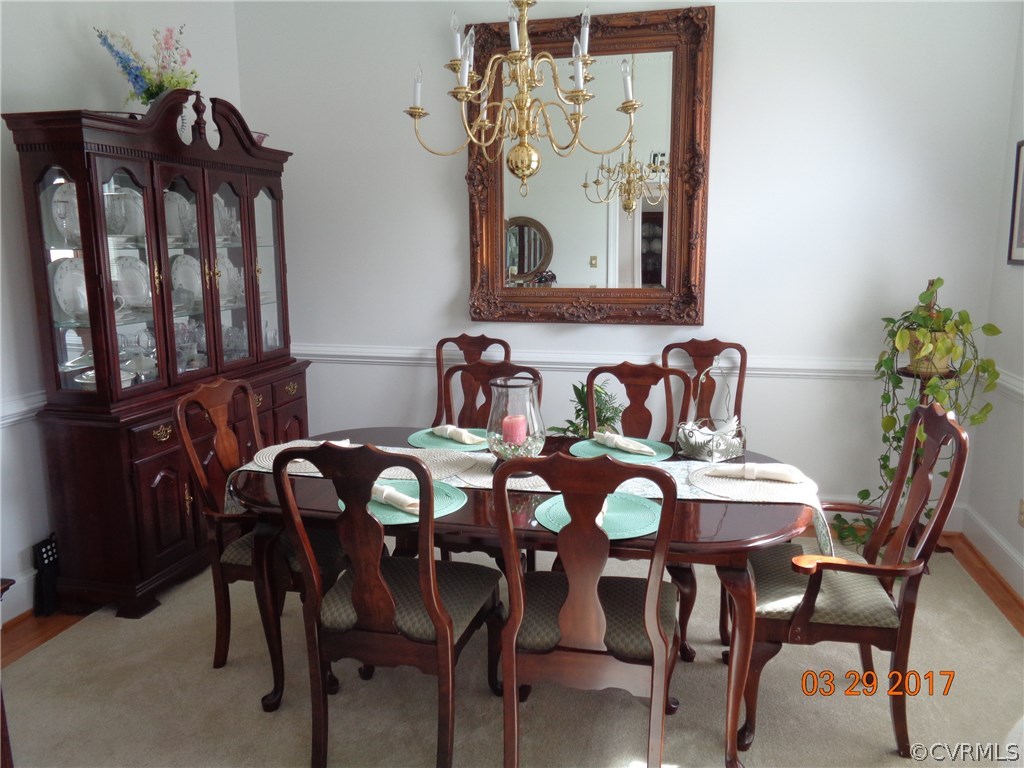 13018 Chipstead Road Chester, VA 23831 - Photo 15 of 47 a view of a dining room with furniture and wooden floor