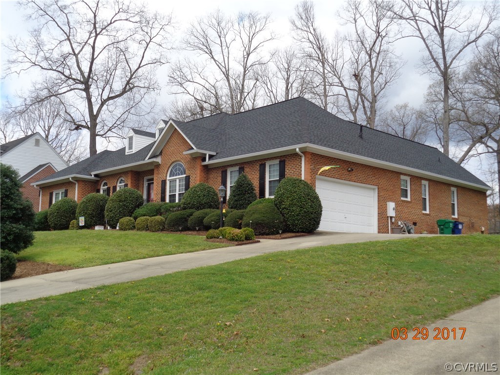 13018 Chipstead Road Chester, VA 23831 - Photo 2 of 47 a front view of a house with a yard and trees