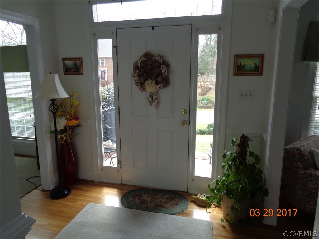 13018 Chipstead Road Chester, VA 23831 - Photo 22 of 47 a view of a hallway with wooden floor and a living room