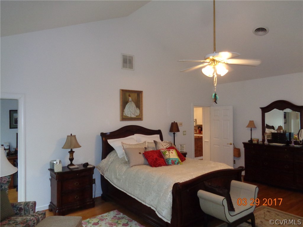 13018 Chipstead Road Chester, VA 23831 - Photo 26 of 47 a bedroom with a bed and a chandelier