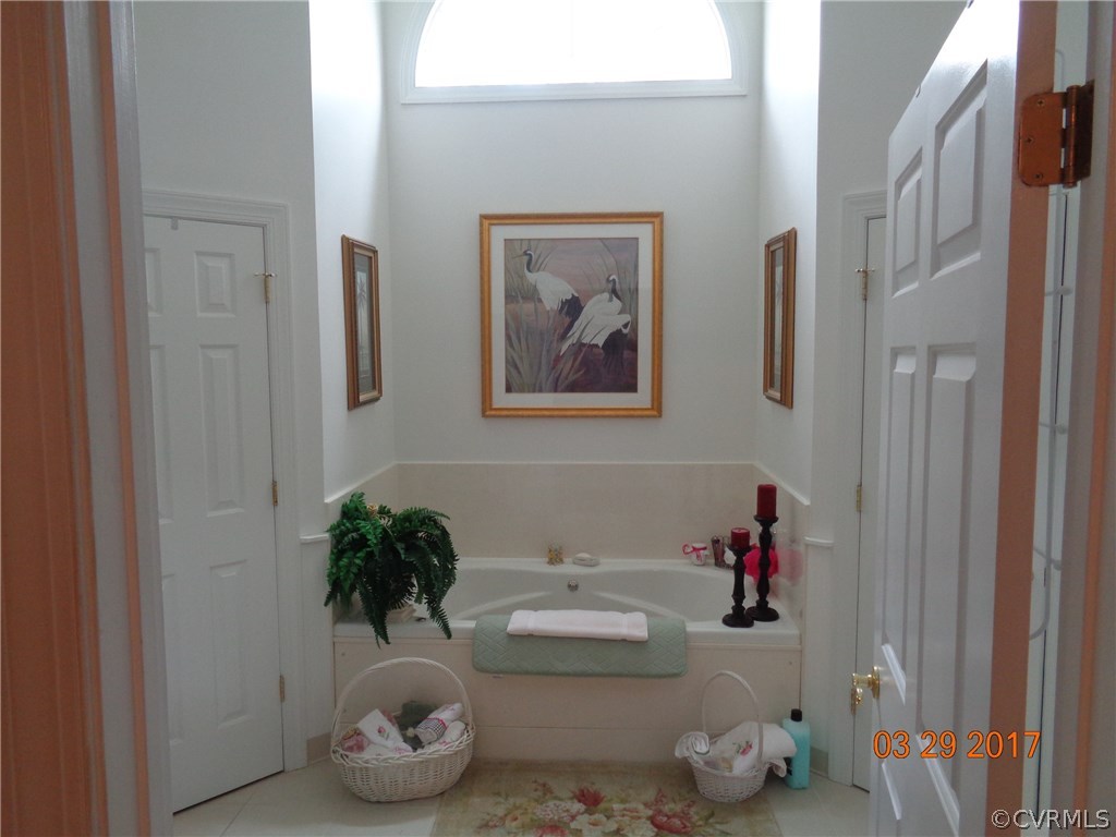 13018 Chipstead Road Chester, VA 23831 - Photo 28 of 47 a bathroom with a tub and a shower