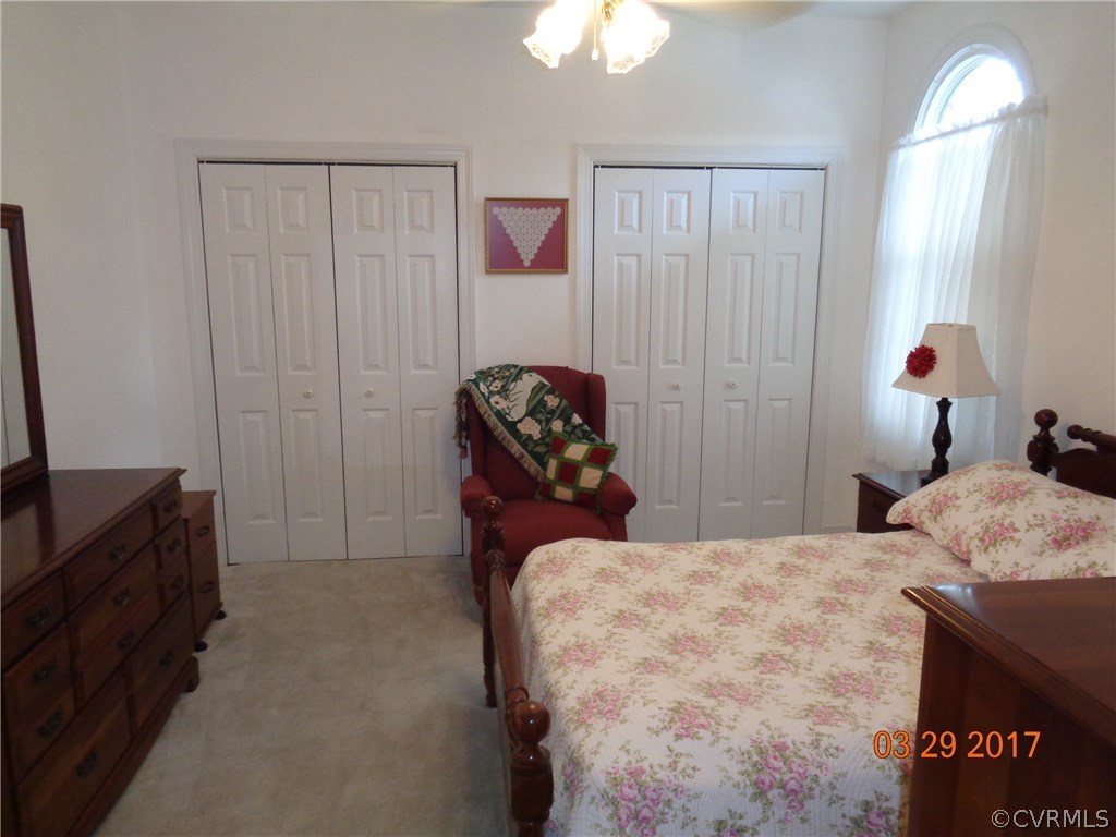 13018 Chipstead Road Chester, VA 23831 - Photo 36 of 47 a bedroom with a bed and a chandelier