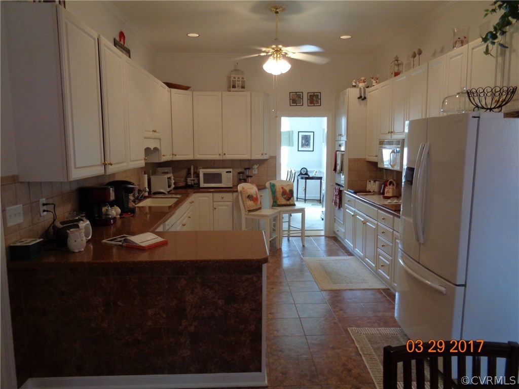 13018 Chipstead Road Chester, VA 23831 - Photo 9 of 47 a kitchen with stainless steel appliances granite countertop a sink refrigerator and cabinets