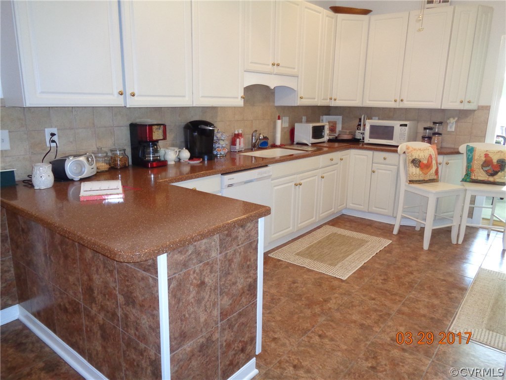 13018 Chipstead Road Chester, VA 23831 - Photo 10 of 47 a kitchen with a sink a stove and cabinets