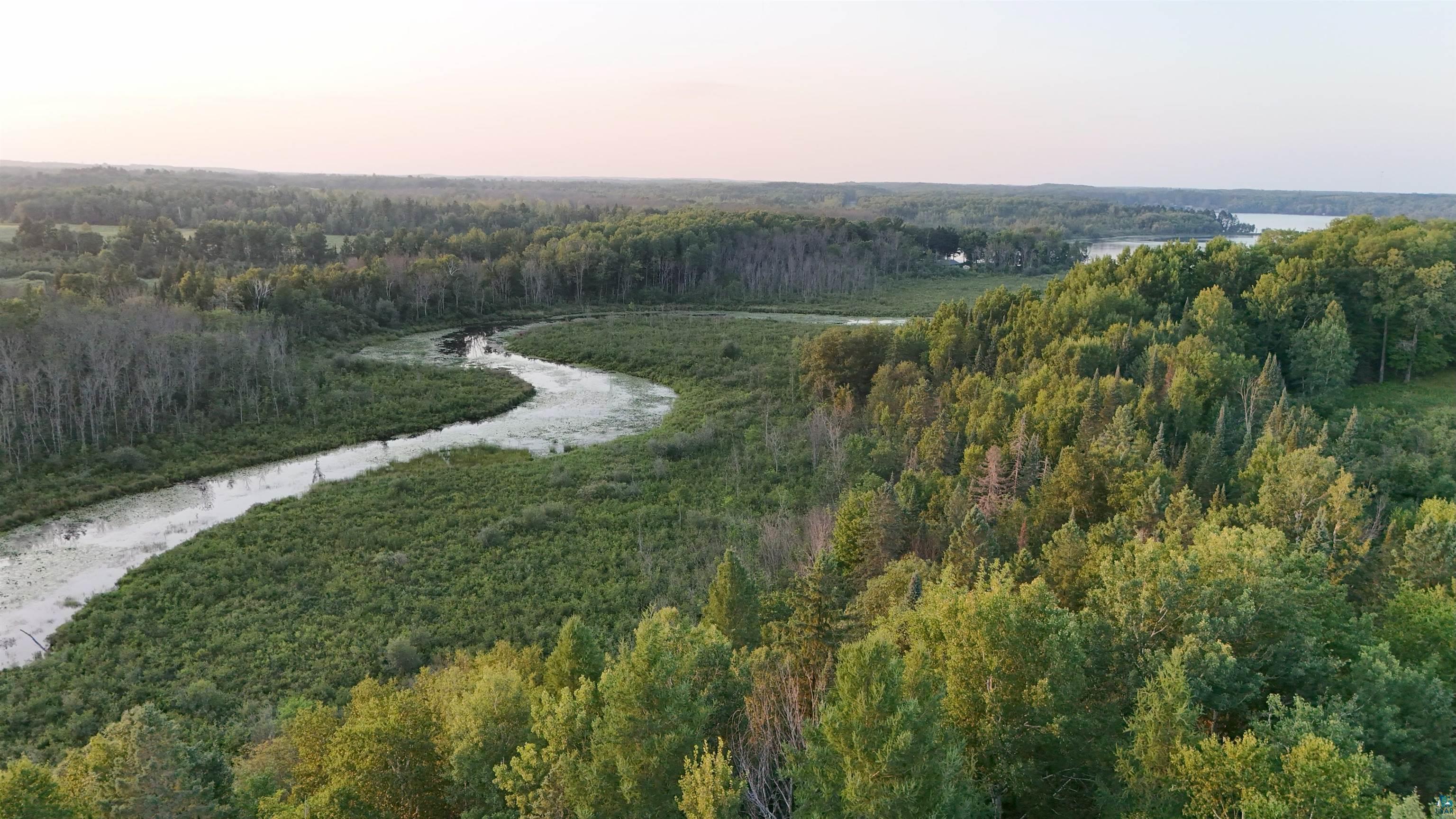 7581 South Marsik Road Lake Nebagamon, WI 54849 - Photo 6 of 7 Aerial view of property and surrounding area featuring a large body of water and a forest