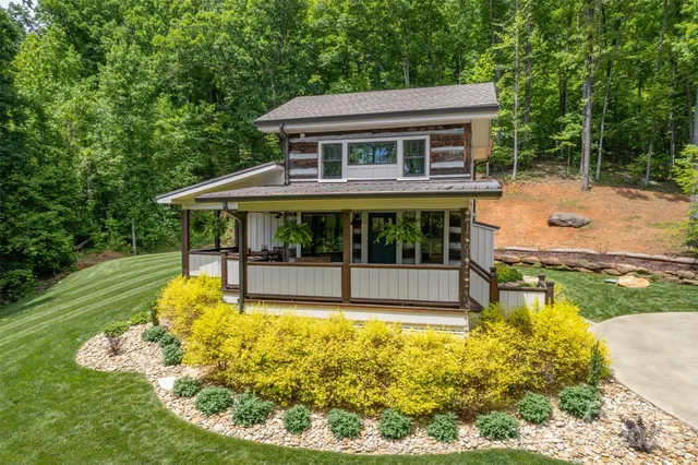 a view of a house with swimming pool and yard