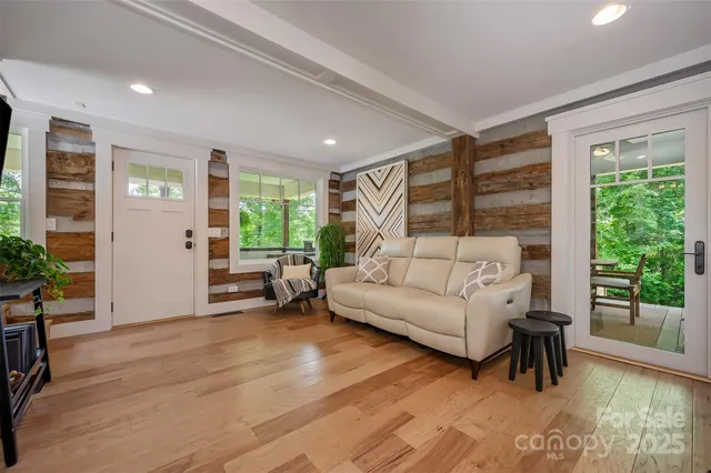 a living room with furniture and wooden floor