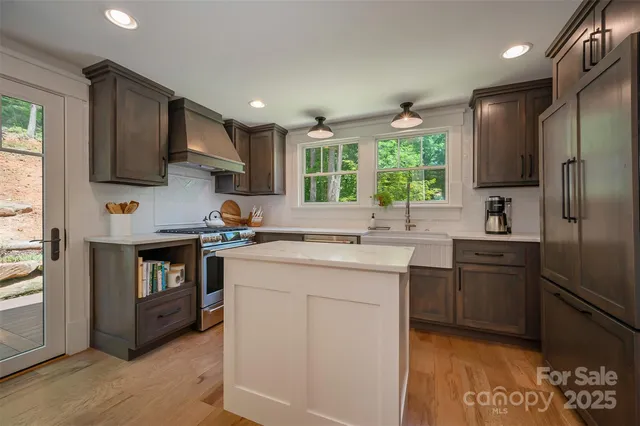 a kitchen with a sink a refrigerator a stove and cabinets