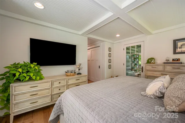 a bed sitting in a room next to a large window