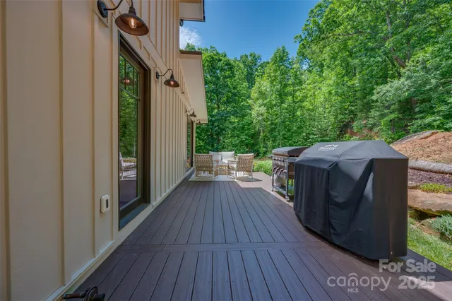 a view of a wooden deck with a yard