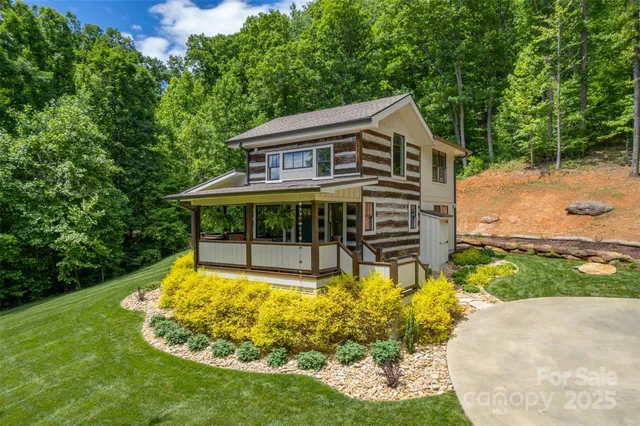 a view of a house with backyard sitting area and garden