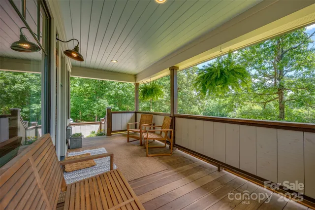 a balcony with chairs and wooden floor