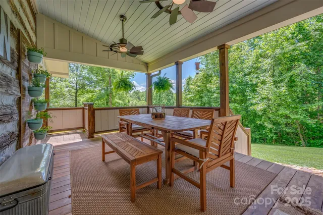a dining room with furniture and a floor to ceiling window