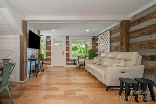a view of a livingroom with furniture and a flat screen tv