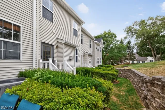 a view of a house with a yard and potted plants