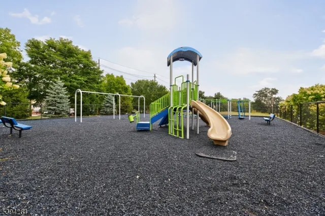 a view of outdoor space with playground and green space