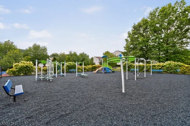 a view of a backyard with tables and chairs