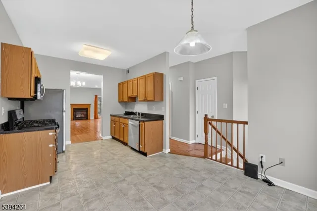 a kitchen with stainless steel appliances granite countertop a stove and a refrigerator