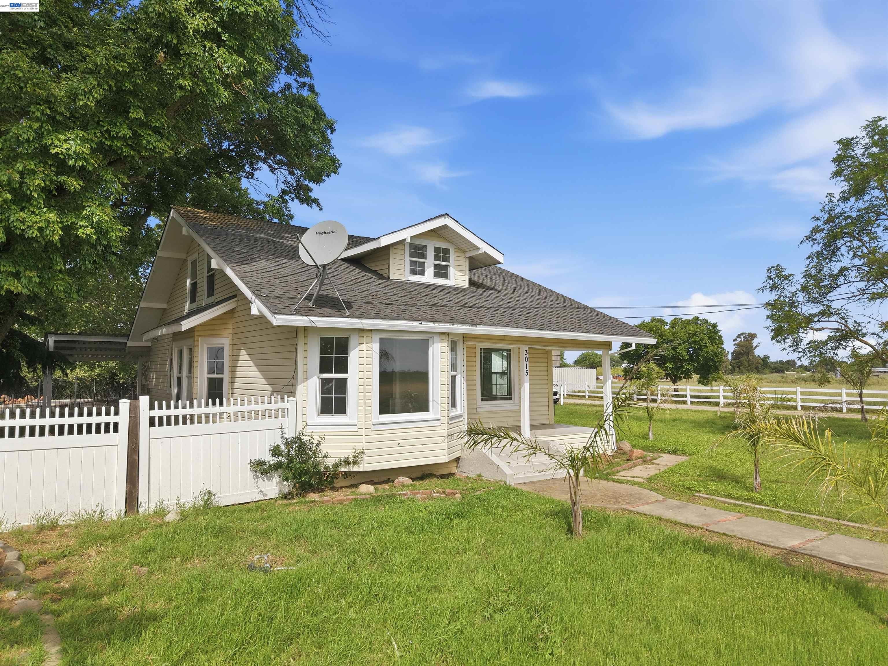 3015 Point Pleasant Road Elk Grove, CA 95757 - Photo 23 of 32 a front view of a house with a yard table and chairs
