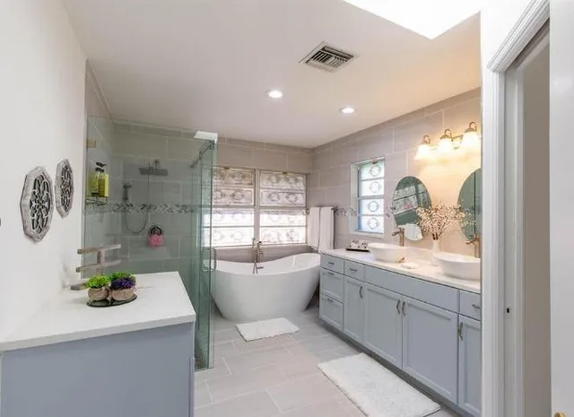 a bathroom with a sink mirror and window