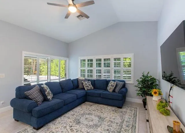 a living room with furniture and a large window