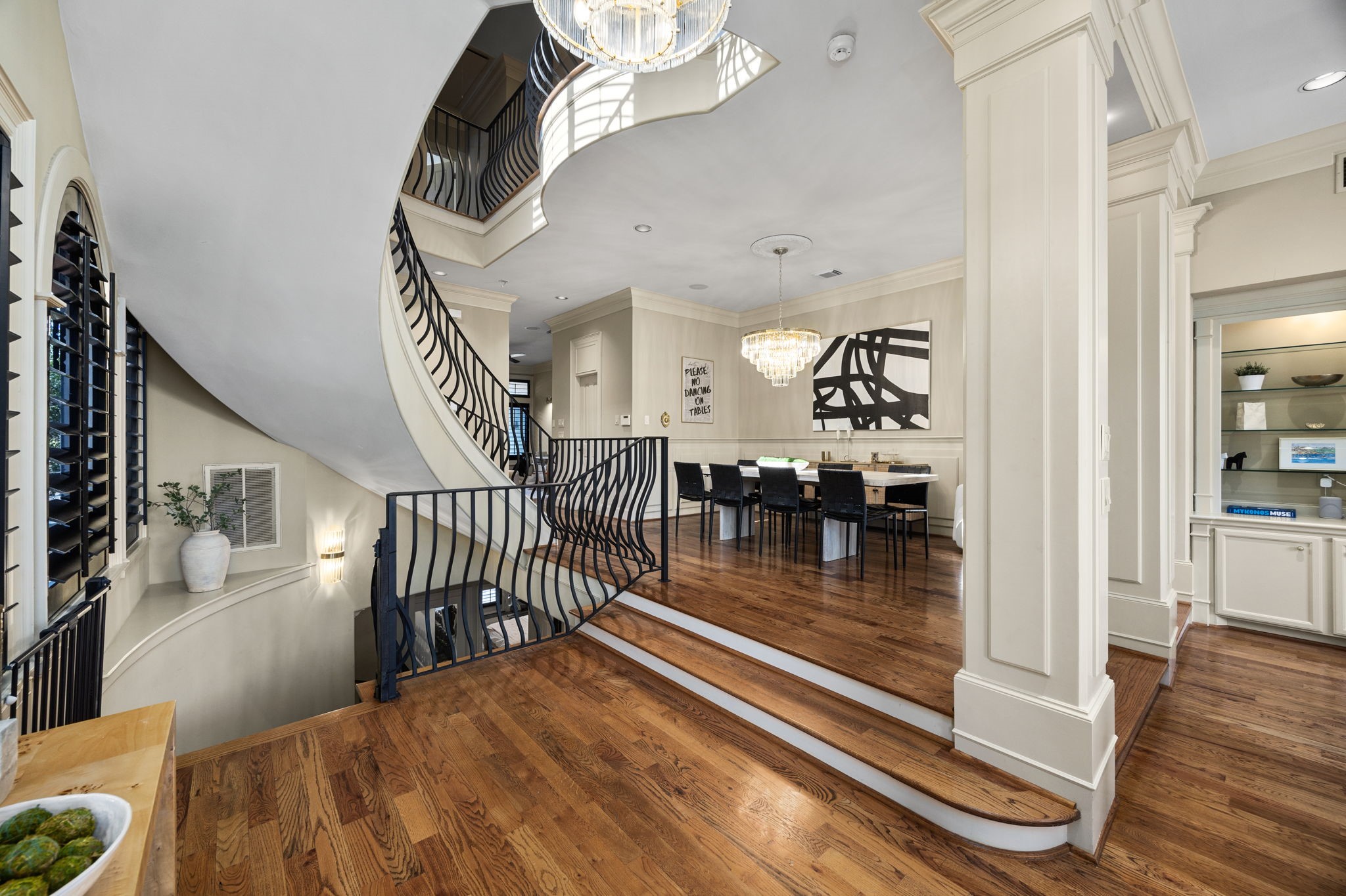 Stunning entryway with elegant staircase and beautiful hardwood floors, setting the tone for luxurious living.