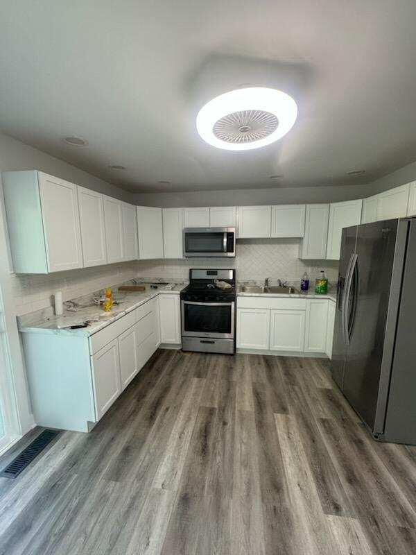 2375 Arrow Street Portage, IN 46368 - Photo 2 of 13 a kitchen with white cabinets and white appliances