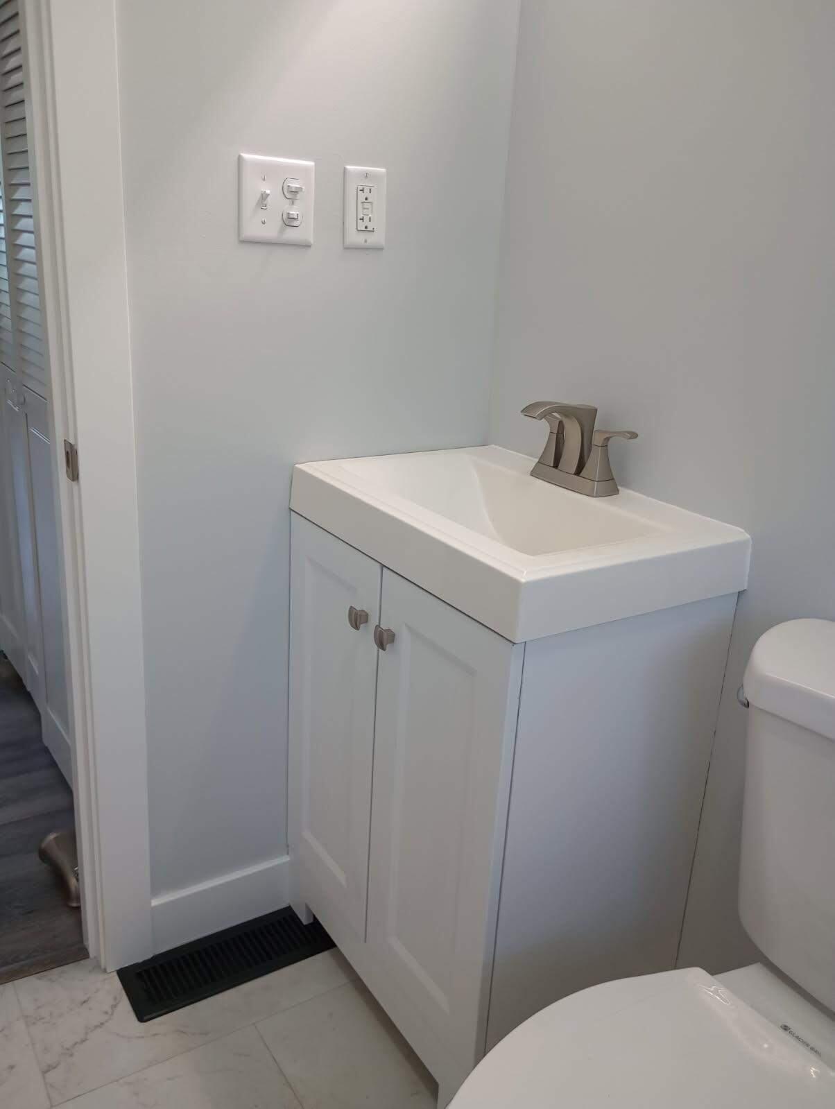 2375 Arrow Street Portage, IN 46368 - Photo 6 of 13 a bathroom with a sink a toilet and a mirror