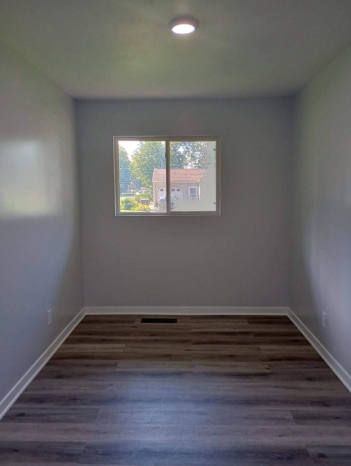 2375 Arrow Street Portage, IN 46368 - Photo 8 of 13 a view of room with wooden floor and window