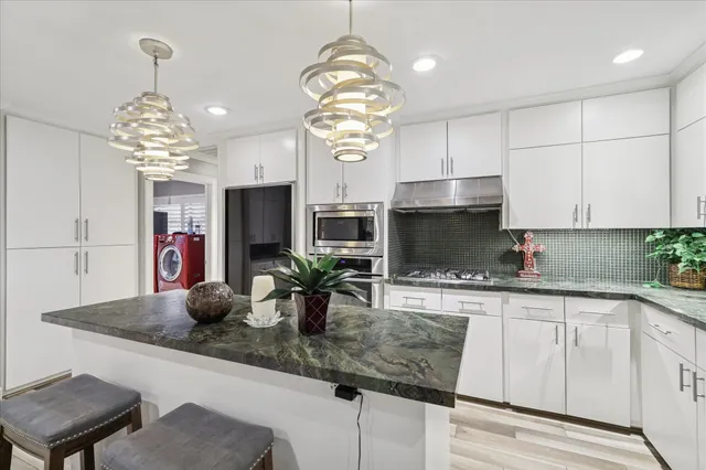 a kitchen with counter space cabinets and appliances