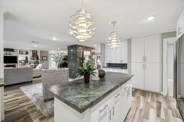 a kitchen with stainless steel appliances granite countertop a sink refrigerator stove and microwave