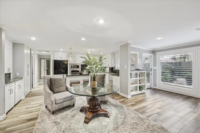 a dining room with furniture and wooden floor