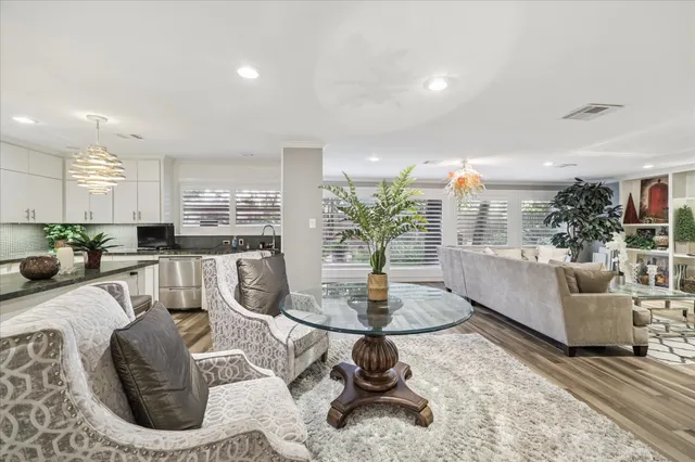 a living room with furniture and a dining table with kitchen view
