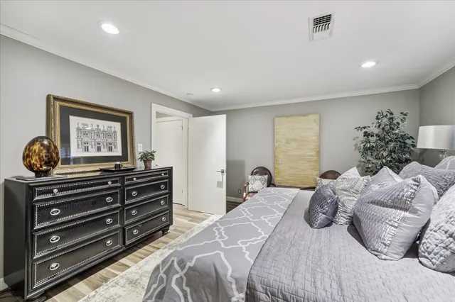 a bedroom with a bed and a painting on the wall