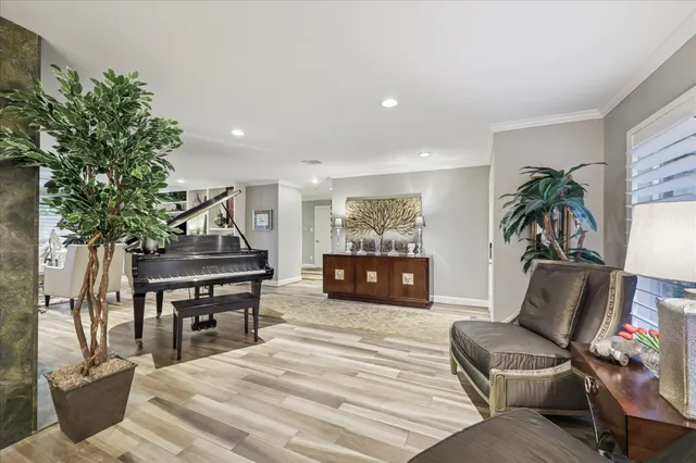 a living room with furniture and a piano