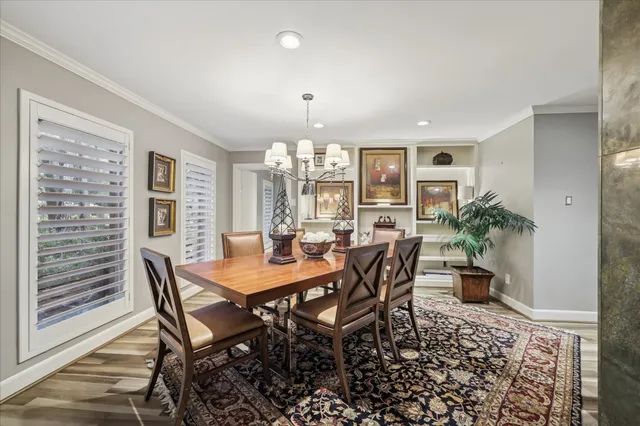 a view of a dining room with furniture and chandelier