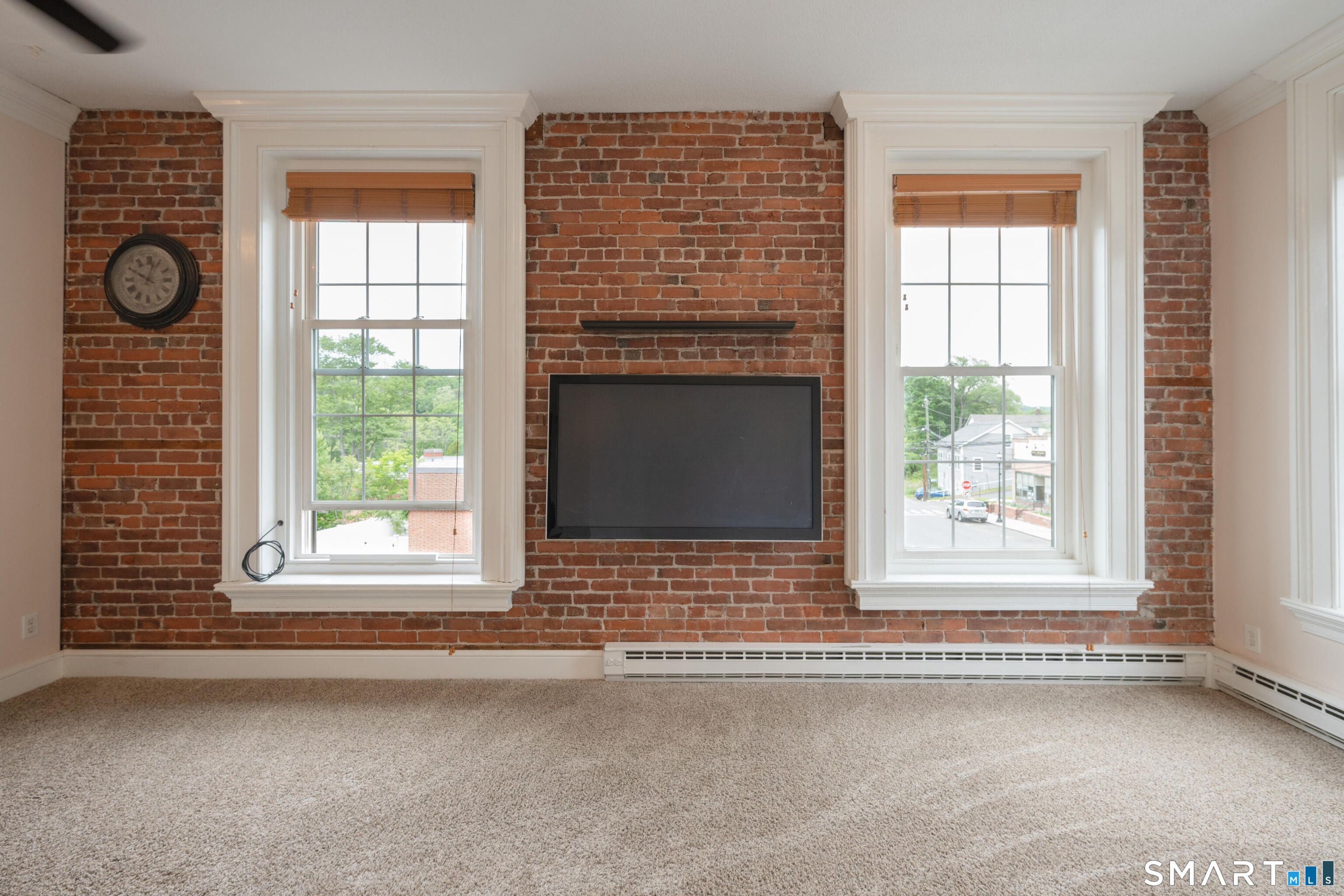 130 Main Street, Unit 2D Canton, CT 06019 - Photo 4 of 25 an empty room with windows and fireplace