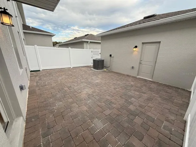 a kitchen with stainless steel appliances kitchen island a stove a chimney and a sink