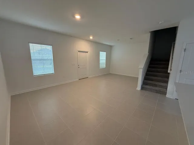 an empty room with windows and closet