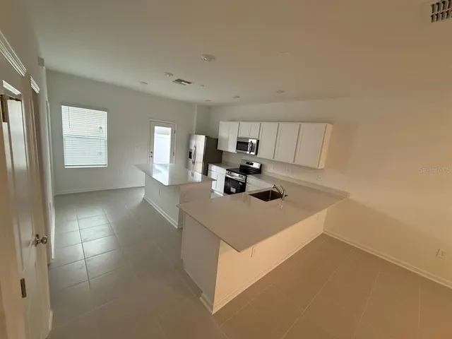 a view of kitchen island with cabinets