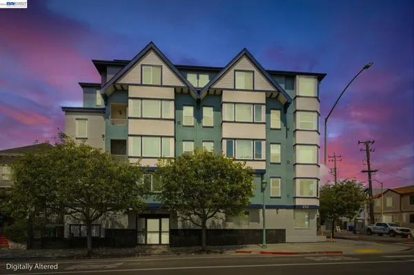a front view of a residential apartment building with a yard
