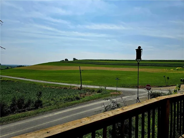 a view of a street with a big yard